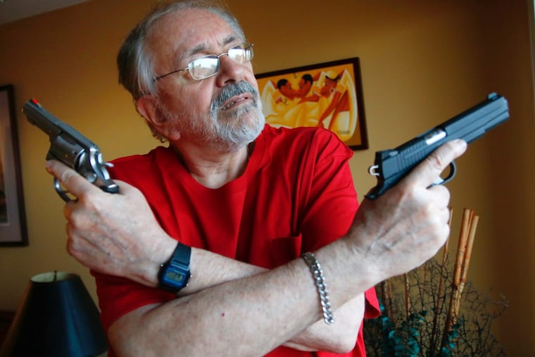 Stu Bykofsky, poses with two of his firearms for which he needs a gun permit in his home in Center City, on Monday evening, Sept. 25, 2017.