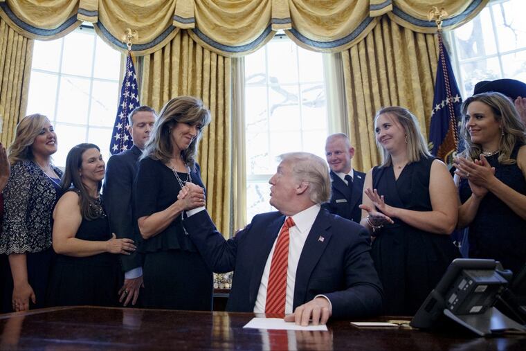 President Donald Trump shakes hands with pilot Tammie Jo Shults, as he meets with crew and passengers of Southwest Airlines Flight 1380 in the Oval Office.