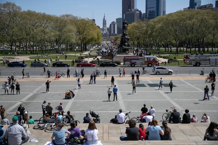 A crowd gathers at the Art Museum steps in anticipation of the Blue Angels and the Thunderbirds flyover on April 28, 2020. The flyover was one of a number of similar events planned across the country in honor of health-care workers in response to the coronavirus pandemic.