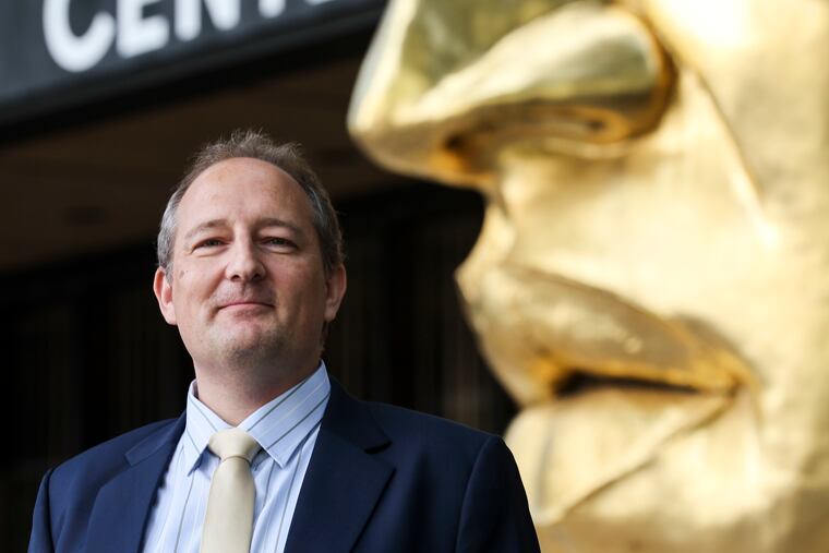 Benjamin P.C. Smith, new head of the Monell Chemical Senses Center, stands outside the Philadelphia research center in front of Face Fragment, the 1975 sculpture by Arlene Love.