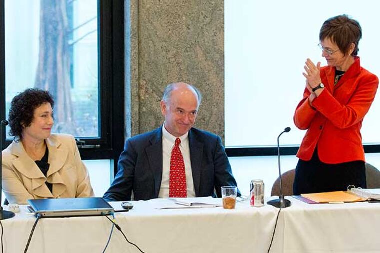 Gil Kemp (center) makes his gift announcement with his wife, Barbara Kemp (left), to the Board of Managers at Swarthmore College; while President Rebecca Chopp (right) applauds. (Photo courtesy of Swarthmore College)