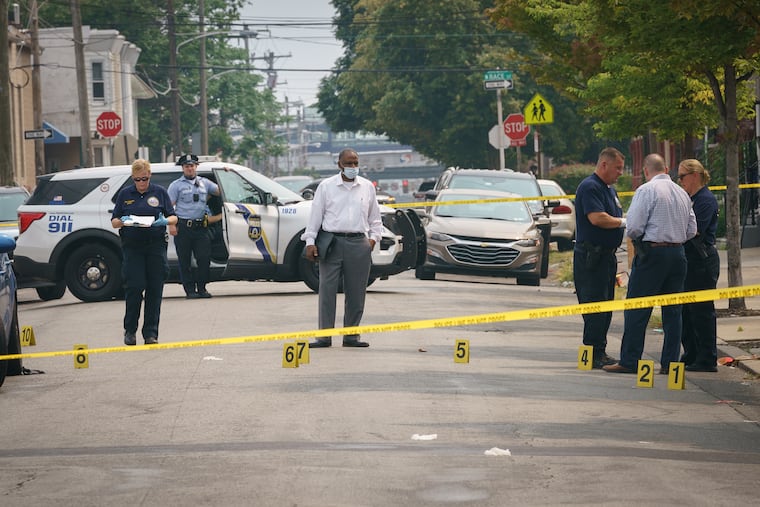 Police investigate a triple shooting that occurred at 56th and Vine Streets on Wednesday.
