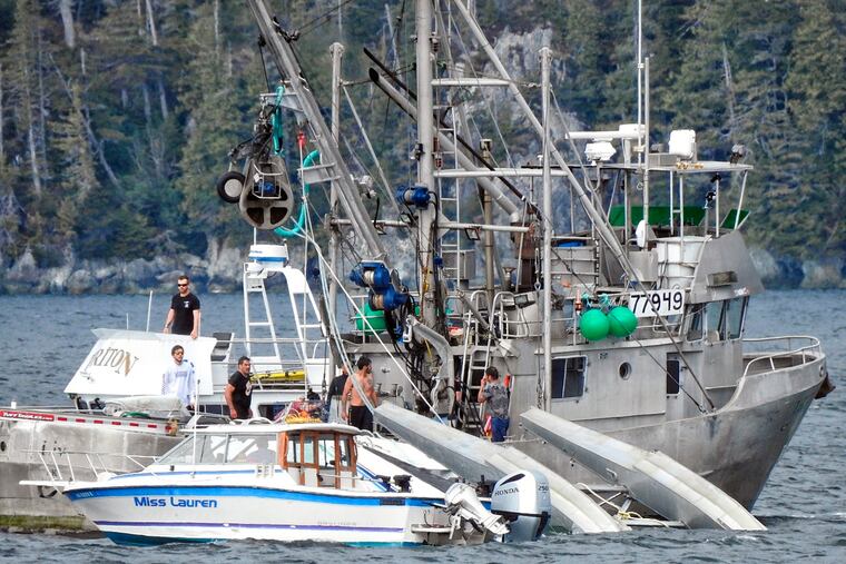 This Monday, May 20, 2019, photo provided by Aerial Leask shows good Samaritans attempting to bring in a floatplane that crashed in the harbor of Metlakatla, Alaska. Officials said the pilot and passenger aboard the plane died, and the National Transportation Safety Board is investigating the crash. (Aerial Leask via AP)