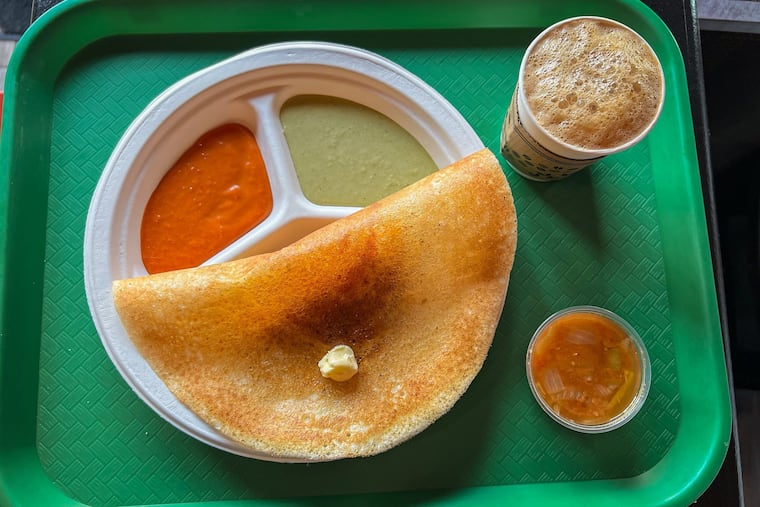Classic masala dosa, topped with a pat of butter, served with filter coffee and sambar at Bengaluru Cafe, 809 N. Second St.