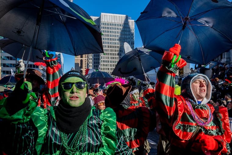 City Hall casts a shadow on the Municipal Services Building as Froggy Carr wenches march.