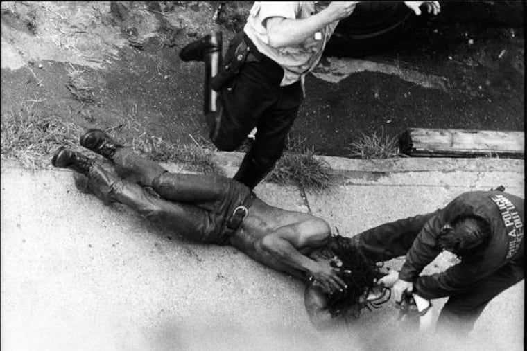 In the first confrontation between police and MOVE, on Aug. 8, 1978, Officer James Ramp was shot and killed. His body and that of a wounded officer were removed. Here, Delbert Africa was kicked and beaten by police officers.