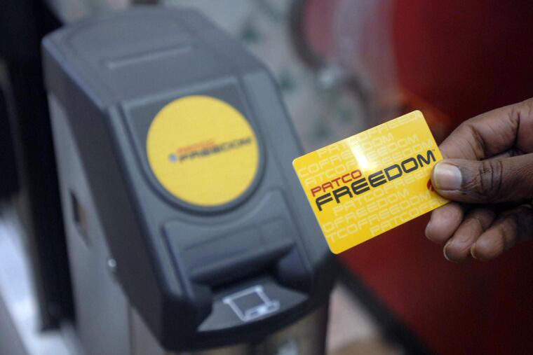 In this Inquirer file photo, a rider holds her PATCO Freedom Card in front of the reader at a turnstile in Camden's Broadway station.