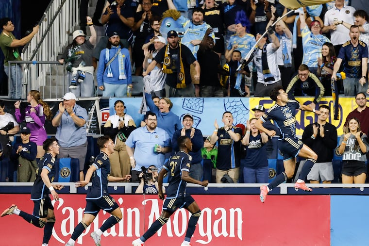 Union midfielder Quinn Sullivan (right) leaps in the air to celebrate scoring the game's opening goal.