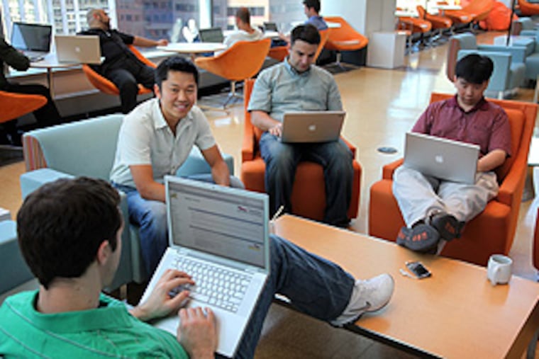 Sean Brown (facing camera), a director of engineering for Fancast.com, sits with some team members in the company’s 15th-floor CIM City lounge, the focal point for Comcast Interactive Media. The space offers abundant comfortable seating for getting work done, and plenty of diversions for clearing the mind or keeping the creative juices flowing.