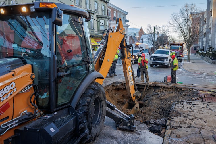 Water department work crew attends to a water main break at West Penn and Cherry Streets in Norristown on Monday.