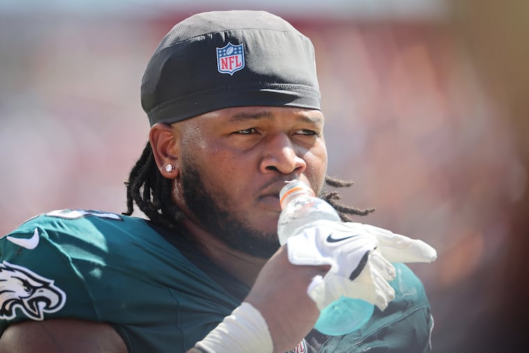Eagles defensive tackle Jalen Carter hydrates during the game against the Buccaneers in Tampa last September.