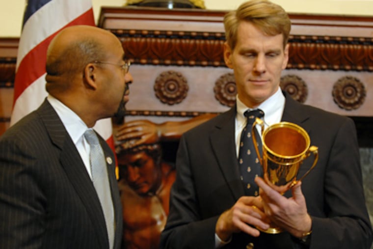 Jack Kelly III, with Mayor Nutter at his side, cradles the long-lost Philadelphia Challenge Cup. (Tom Gralish / Staff Photographer)