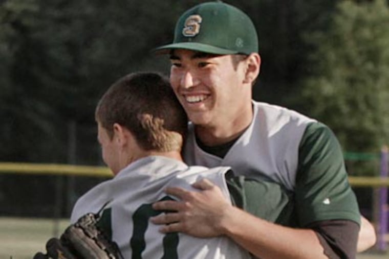 Seneca pitcher Kevin Comer is hugged by teammate Ty Lyons after winning the Group
3 final. (Elizabeth Robertson/Staff Photographer)