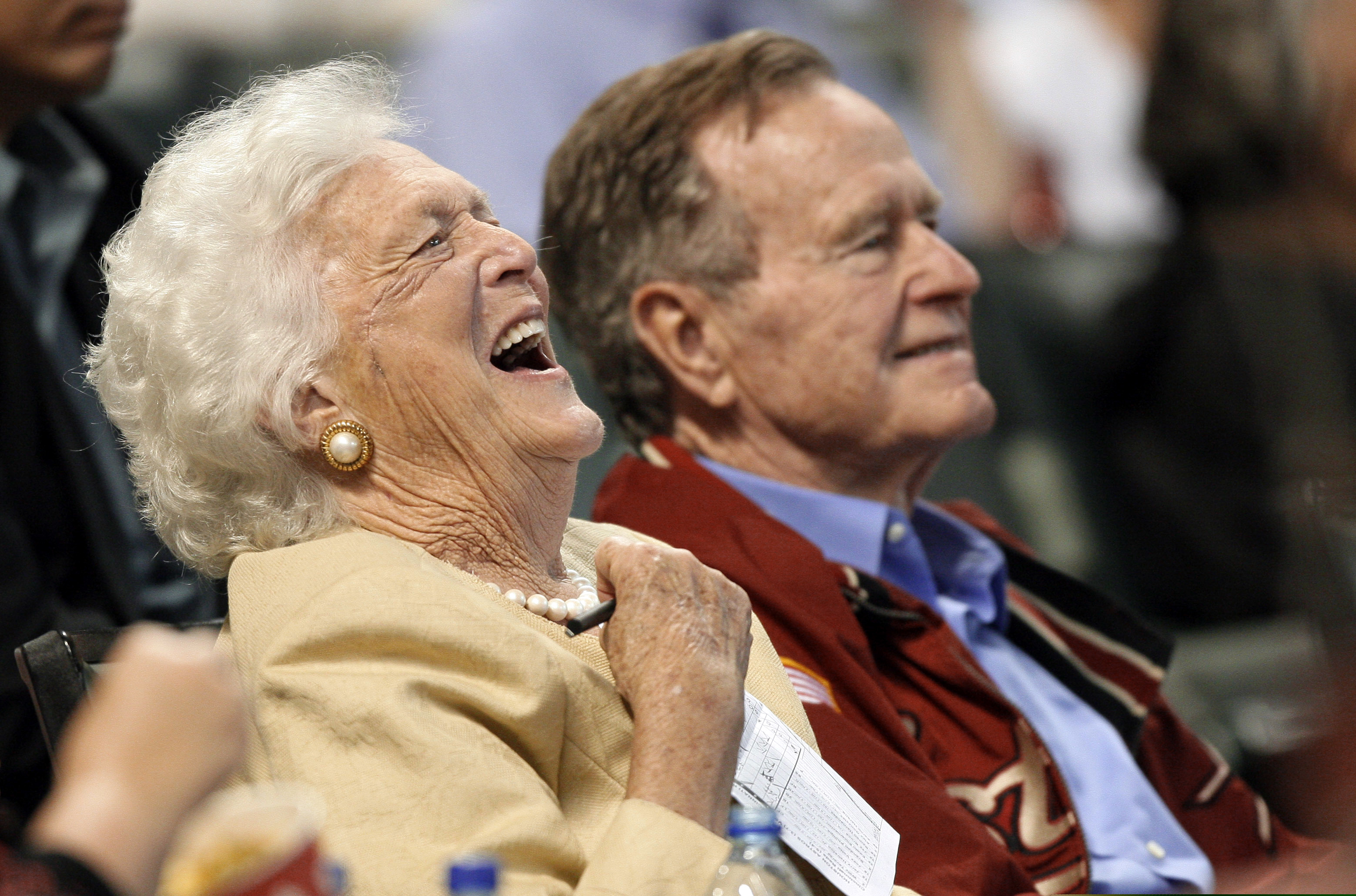 In this April 18, 2009, file photo, Barbara Bush laughs alongside former President George H.W. Bush, right, as they attend a baseball game in Houston.
