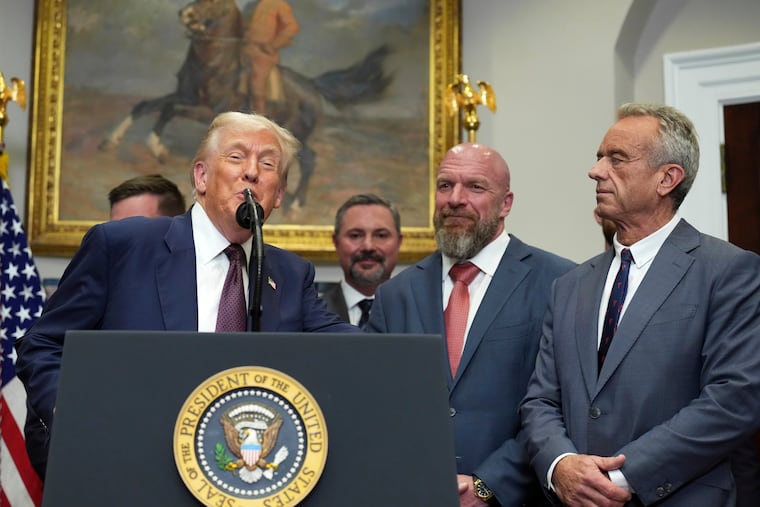 President Donald Trump, from left, speaks as Cody Campbell, WWE CCO Triple H and Health and Human Services Secretary Robert F. Kennedy Jr. listen during an event for the signing of an executive order restarting the Presidential Fitness Test in public schools, Thursday, July 31, 2025, in the Roosevelt Room of the White House in Washington.