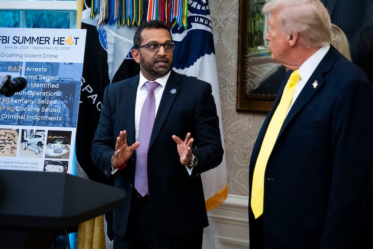 President Donald Trump speaks with FBI Director Kash Patel during a press conference in the Oval Office of the White House in Washington on Wednesday, Oct, 15, 2025. The F.B.I. director, following a strategy from President Trump, has filed six defamation lawsuits against news media companies and commentators in nearly seven years.