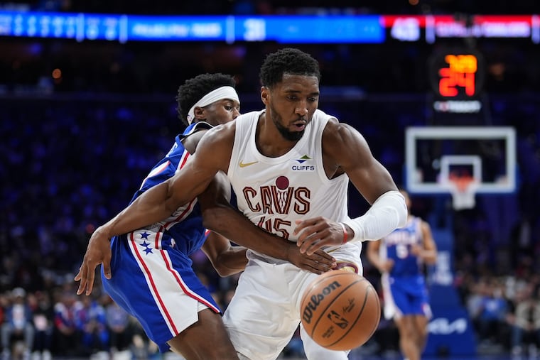 Cavaliers' Donovan Mitchell (right) is defended by Sixers rookie VJ Edgecombe during the first half of Wednesday's game.