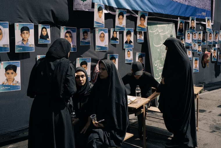 In Tehran, family members set up a memorial to victims of the strike on an elementary school in Minab on the first day of the U.S.-Israeli assault on Iran.
