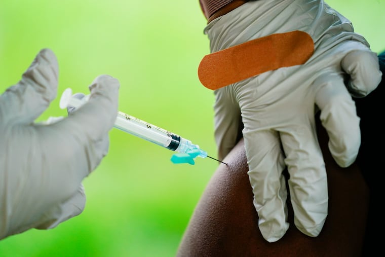 A health worker administers a dose of the COVID-19 vaccine during a vaccination clinic in Reading in 2021.