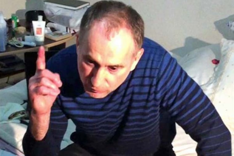 In this image taken from a mobile phone video, the father of USA Boston bomb suspects, Anzor Tsaraev reacts as he talks to the media about his sons, in his home in the Russian city of Makhachkala, Friday April 19, 2013. One son is now dead, and one son Dzhokhar Tsaraev is still at large on Friday suspected in Monday's deadly Boston Marathon bombing which stunned friends who have pleaded for the surviving brother, described as bright and outgoing young man, to turn himself in and not hurt anyone.(AP Photo)