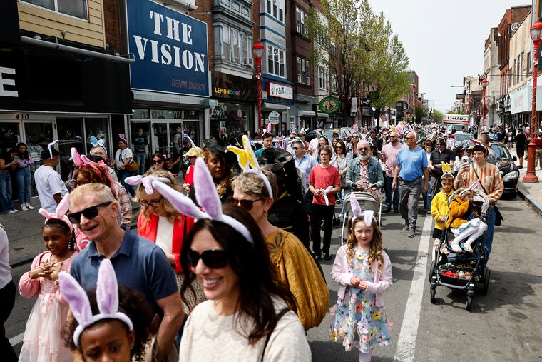 People walk down South Street during the 92nd annual Easter Promenade on Sunday in Philadelphia. After strolling down South Street, people gathered for a Best Dressed Contest at Headhouse Plaza.