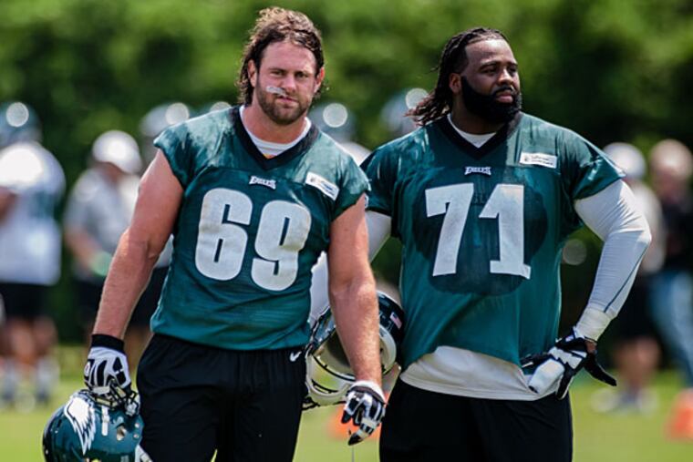 Evan Mathis (69) and Jason Peters (71) take a breather between drills during practice. (Matthew Hall/Staff Photographer)