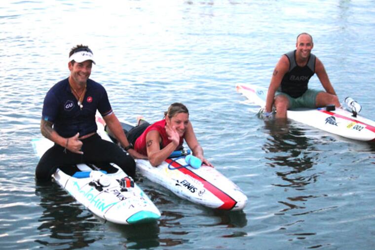 Paraplegic athlete Dawn Robinson with her trainer Bruckner Chase (left) and paddler Dave Allison as she completed the Upper Township Beach Patrol 5 mile paddle board race in Strathmere on July 27.
(Photo courtesy of Jeffrey G. Barnes)