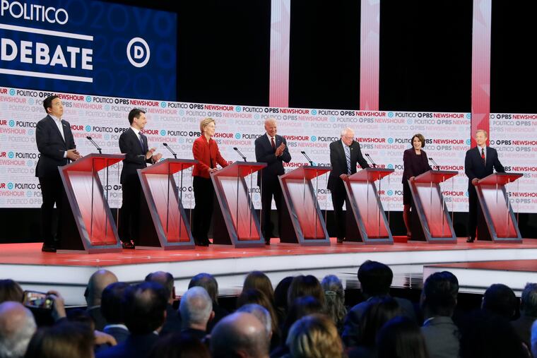 Democratic presidential candidates (from left) Andrew Yang, Pete Buttigieg, Sen. Elizabeth Warren, former Vice President Joe Biden, Sen. Bernie Sanders, Sen. Amy Klobuchar, and Tom Steyer participate in a Democratic presidential primary debate Thursday in Los Angeles.