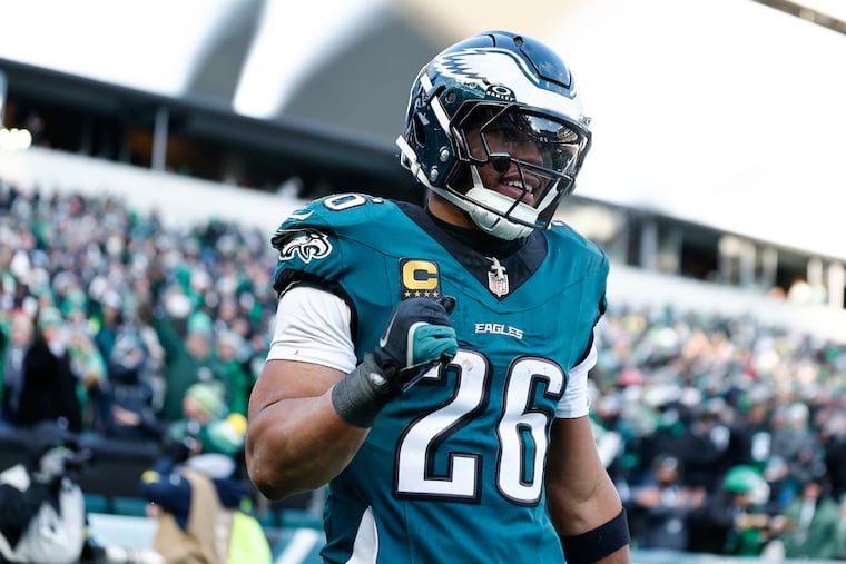 Eagles running back Saquon Barkley pumps his fist after tight end Dallas Goedert scored a third-quarter touchdown against on Sunday against the Raiders.