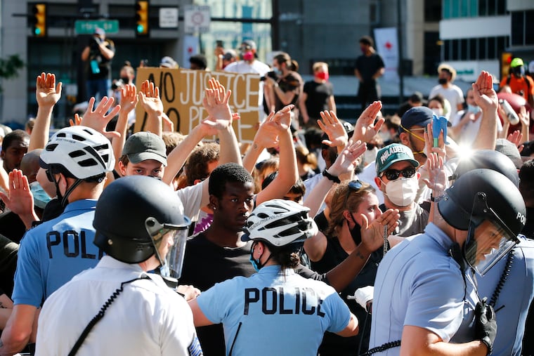 Police officers shove back protester during a Justice for George Floyd Philadelphia Protest at the MSB on Saturday, May 30, 2020.