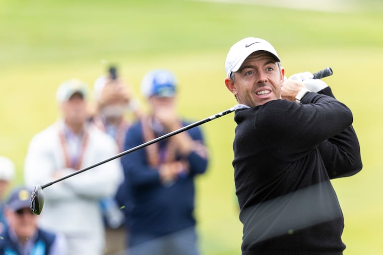 Rory Mcllroy hits his approach to the par-5 ninth green.