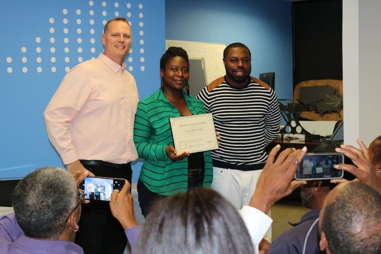 Inmates to Entrepreneurs graduate Jessica Bladenburg stands alongside program mentors Scott Jennings and Lawrence Carpenter.