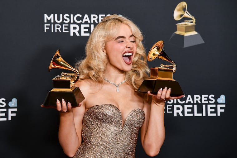 Bucks County native Sabrina Carpenter poses with the Grammy Awards for best pop solo performance and best pop vocal album on Sunday.