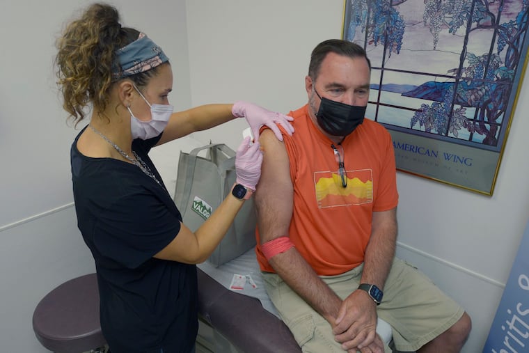 Robert Terwilliger (right) of Williamsburg, Pa., who is participating in a Lyme disease vaccine trial at the Altoona Center for Clinical Research, is injected with either the new vaccine or a placebo, by registered nurse Janae Roland, Friday, Aug. 5, 2022, in Duncansville, Pa. Lyme is a growing problem, with cases steadily rising and warming weather helping ticks expand their habitat.