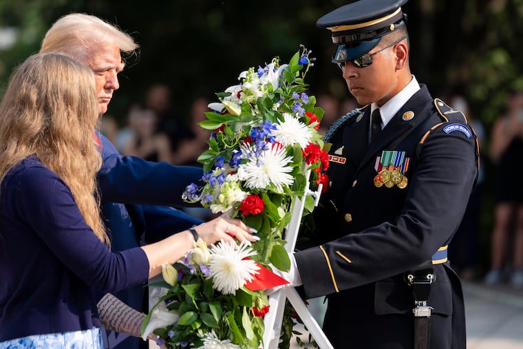 Misty Fuoco, left, sister of Nicole Gee, and Republican presidential nominee former President Donald Trump place a wreath in honor of Sgt. Nicole Gee, at the Tomb of the Unknown Solider at Arlington National Cemetery on Aug. 26 in Arlington, Va.