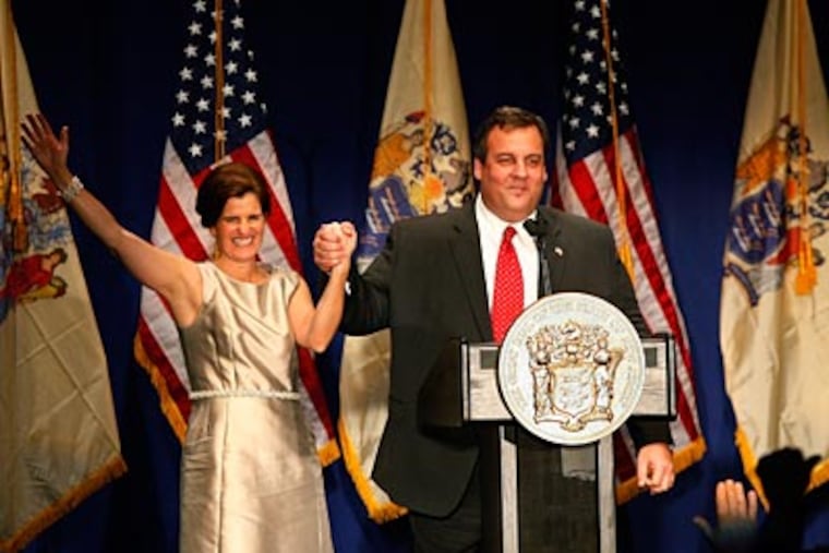 Gov. Chris Christie holds hands with wife Mary Pat Christie as he speaks at an Inauguration event Tuesday, Jan. 19, 2010, in Newark, N.J. (AP Photo/Mel Evans)