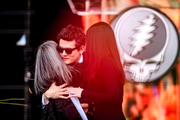 John Mayer embraces Natascha Münter during a public memorial for her husband, Grateful Dead guitarist Bob Weir, on Saturday, Jan. 17, 2026, in San Francisco.
