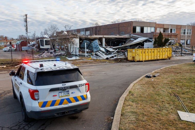 Bristol Township police officers guard the scene outside the Bristol Health & Rehab Center Christmas morning, two days after a deadly explosion killed two and injured 20 at the nursing facility.