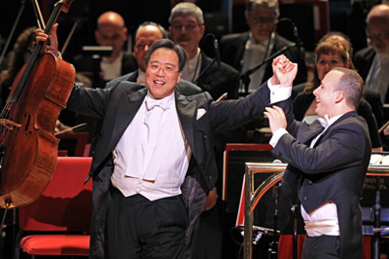Cellist Yo-Yo Ma accepts applause from the crowd and congratulations from conductor Yannick Nézet-Séguin after performing Tchaikovsky's "Variations on a Rococo Theme." (Michael Bryant / Staff Photographer)