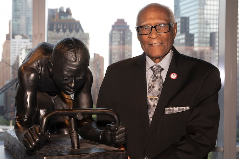 Mr. Douglas poses in 2019 in New York at the unveiling of a sculpture by Kadir Nelson called "The Major." It honors celebrated Black cyclist Marshall “Major” Taylor.