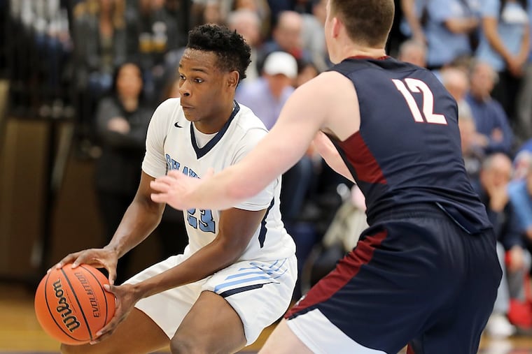 Daevon Robinson of Shawnee is guarded by Ryan Ems of Eastern during the first quarter.