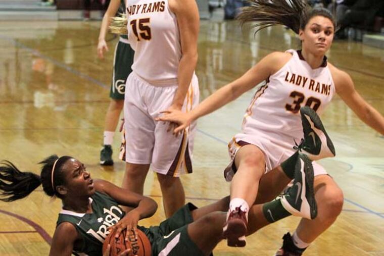Camden Catholic's Michelle Obasi gets the rebound after tangling with Gloucester Catholic's Mary Gedaka. (David M Warren/Staff Photographer)
