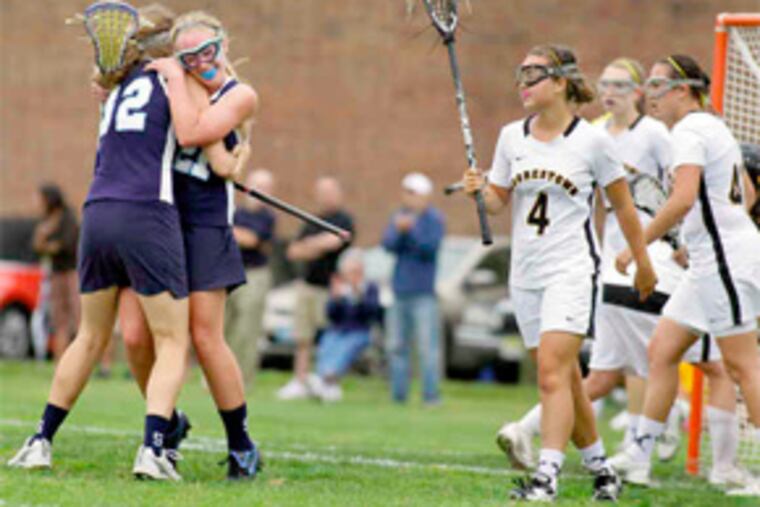Kristin Mutch and Karlee Dean (32) celebrate a Shawnee goal. Moorestown lost to a New Jersey opponent for the first time since 1999.