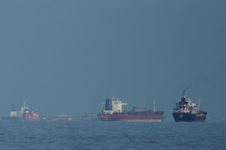 FILE - Oil tankers and cargo ships line up in the Strait of Hormuz as seen from Khor Fakkan, United Arab Emirates, Wednesday, March 11, 2026.