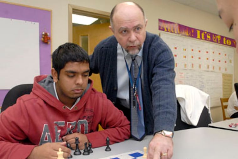 Nodar Jagodnishili, assistant coach of the state championship Fels chess team, suggests a move to senior Cijo Joseph. (April Saul / Staff Photographer)