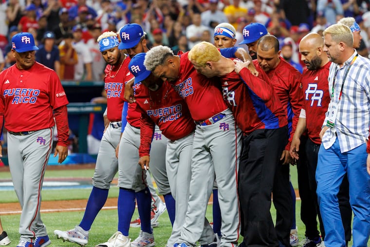 Puerto Rico pitcher Edwin Diaz is helped off the field after injuring his right knee celebrating a win over the Dominican Republic in the WBC on Wednesday in Miami.