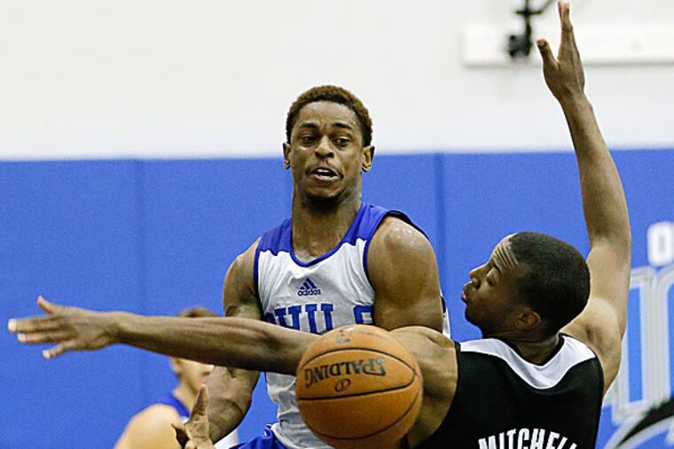 The 76ers' Casper Ware passes the ball past the Rockets' Akil Mitchell. (John Raoux/AP)