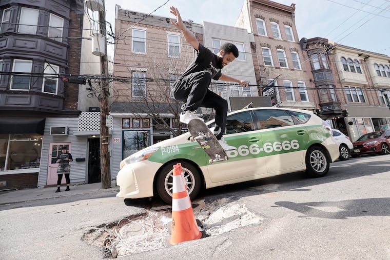 Philly skateboarder Myquel “Quel” Haddox gets some air as he jumps over a large hole on the 700 block of South 4th Street in Philadelphia on March 12, 2025.