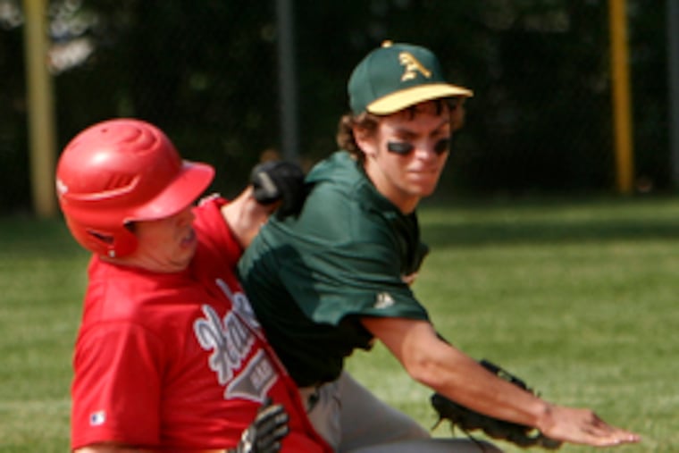 Audubon's Kyle Urban throws to first to complete the double play after getting Haddon Township's Frank Trautz at second.