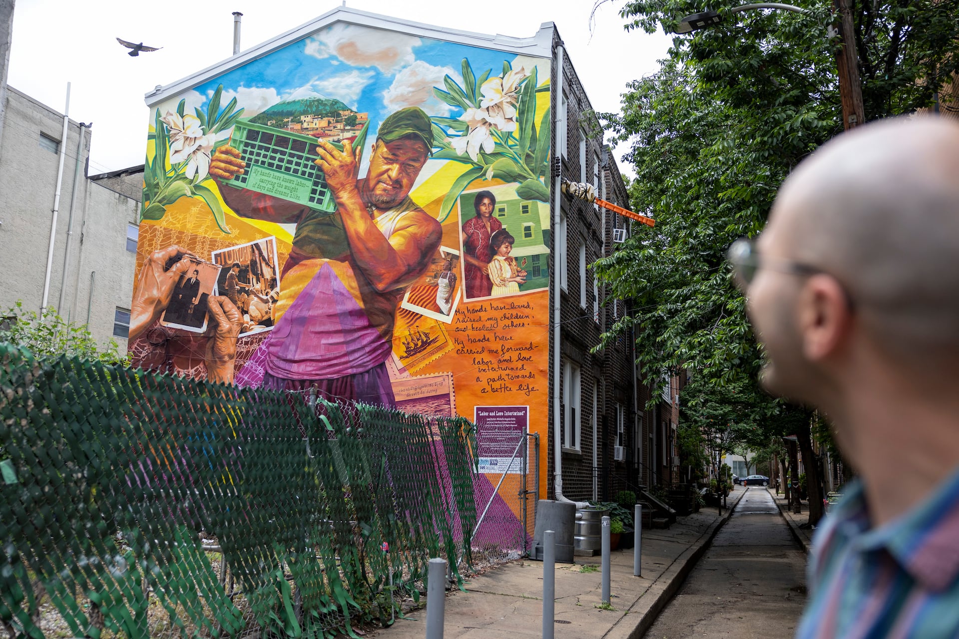 Brendan McCreath looks at the mural painted on the side of his rowhouse.